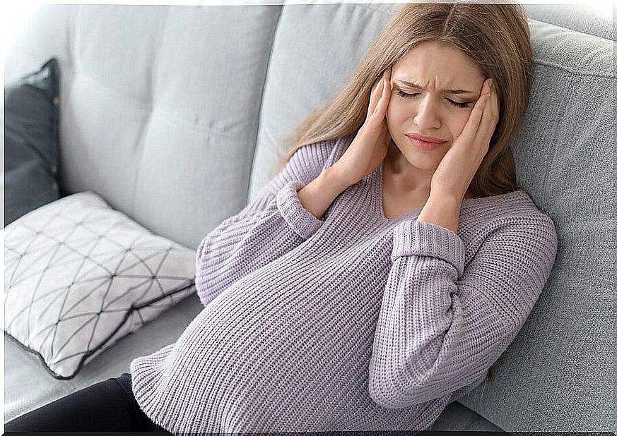 Woman with headache from prenatal depression.