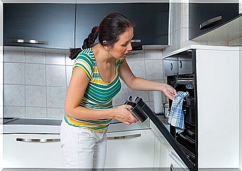 Woman preheating the oven