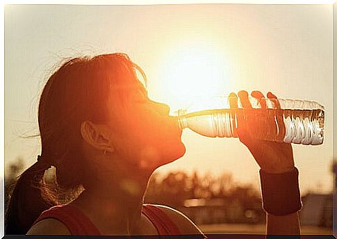 Woman drinking water in the sun