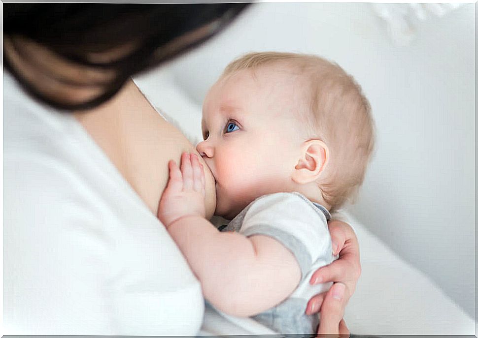 Mother breastfeeding her child because breastfeeding helps to lose weight.