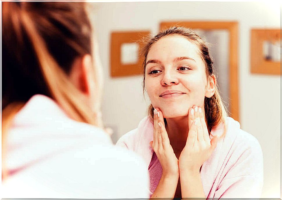 Woman washing her face.